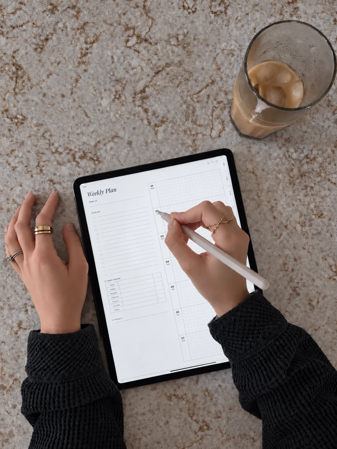 Digital weekly planning workspace with tablet, stylus and coffee