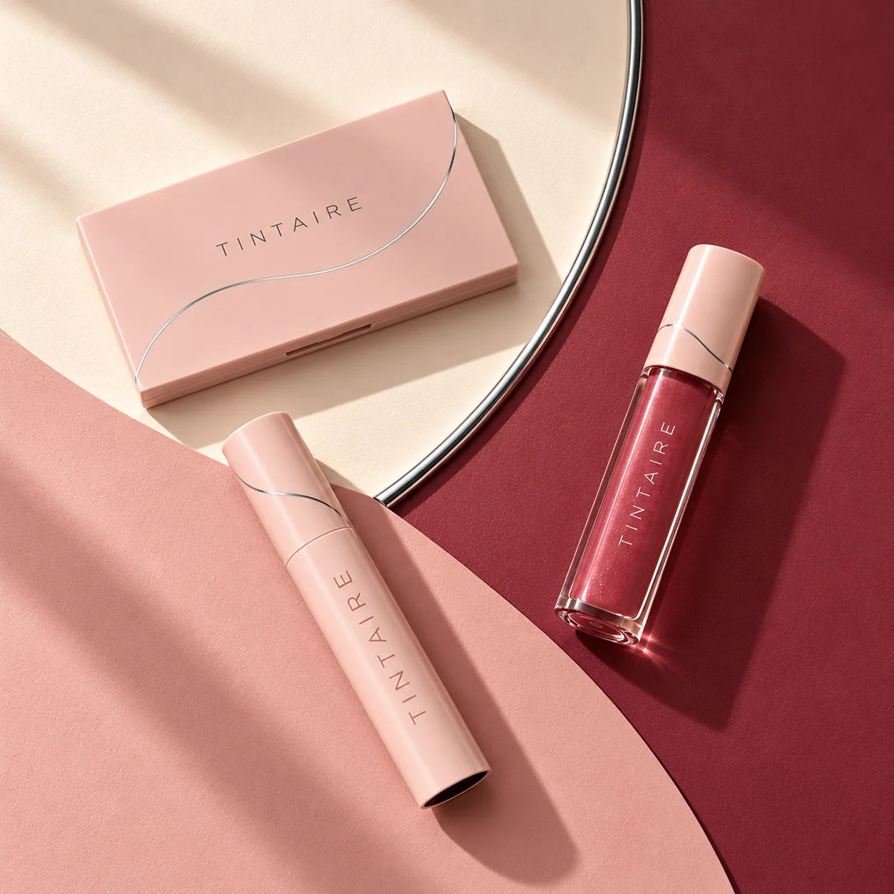 TINTAIRE palette, mascara and lip colour arranged as a complete colour wardrobe